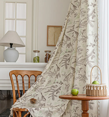 Beige curtain with bird and botanical print in brown and green, featuring decorative tassel trim for a rustic, nature-inspired look.