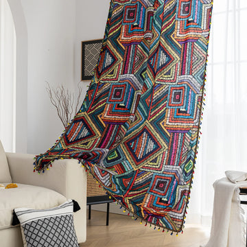 Vibrant geometric bohemian curtain with bold multicolor diamond patterns, featuring intricate woven-style designs and colorful tassel trim — ideal for adding a lively, artistic statement to any room décor.