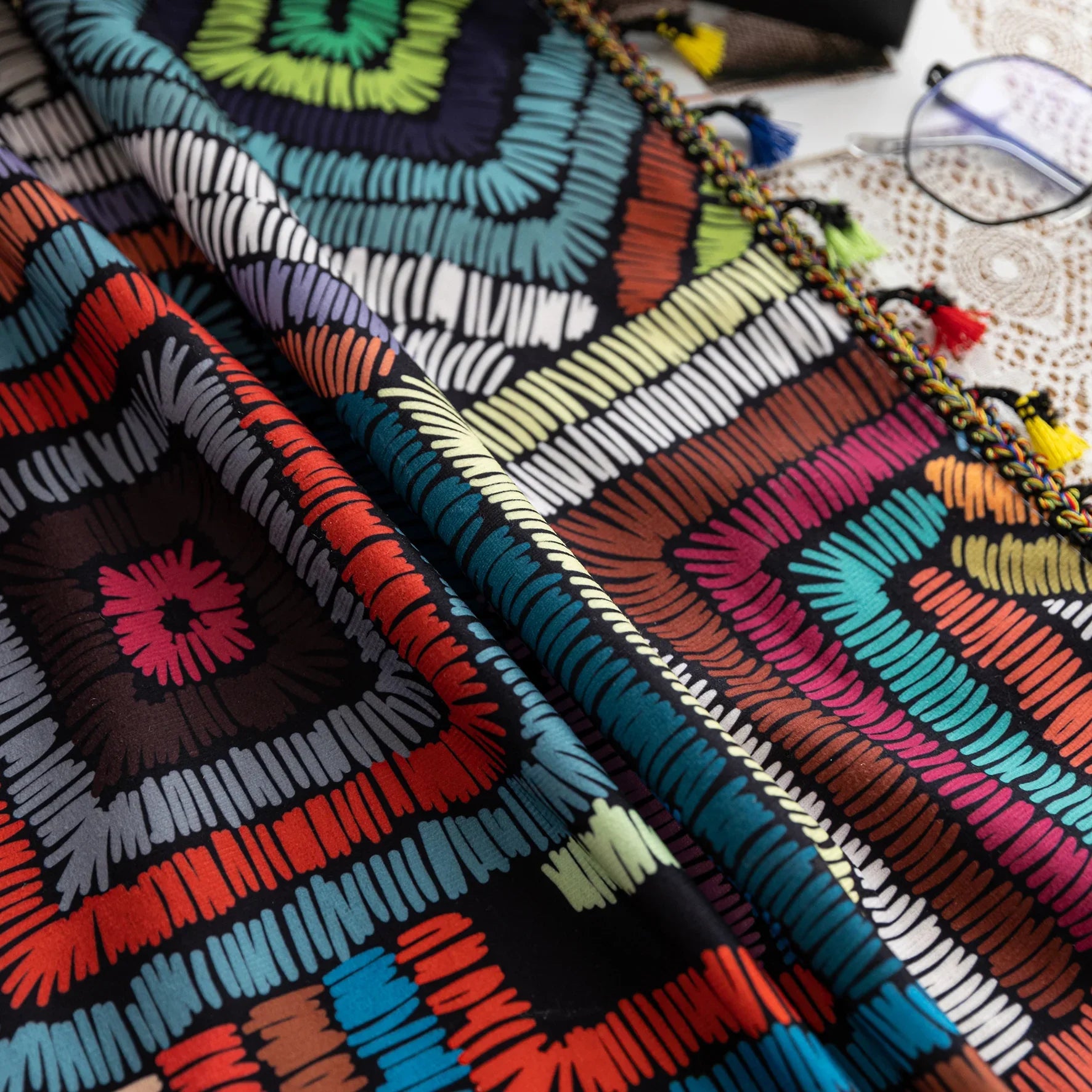 Vibrant geometric bohemian curtain with bold multicolor diamond patterns, featuring intricate woven-style designs and colorful tassel trim — ideal for adding a lively, artistic statement to any room décor.