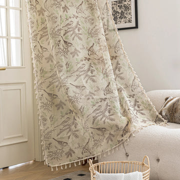 Beige curtain with delicate bird and botanical print in soft brown and green tones, finished with tassel trim, adding a rustic and nature-inspired charm to living room décor.