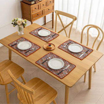 Colorful woven placemat with intricate diamond patterns, adding a vibrant boho touch while protecting your dining table.