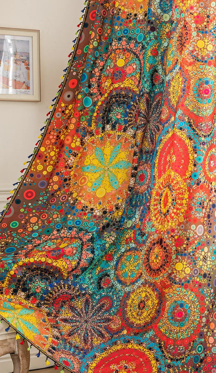 A colorful bohemian curtain with vibrant circular patterns in red, brown, blue, and yellow, decorated with multicolor tassels and braided trim, adding an artistic and lively touch to home d¨¦cor.