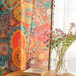 A colorful bohemian curtain with vibrant circular patterns in red, brown, blue, and yellow, decorated with multicolor tassels and braided trim, adding an artistic and lively touch to home d¨¦cor.