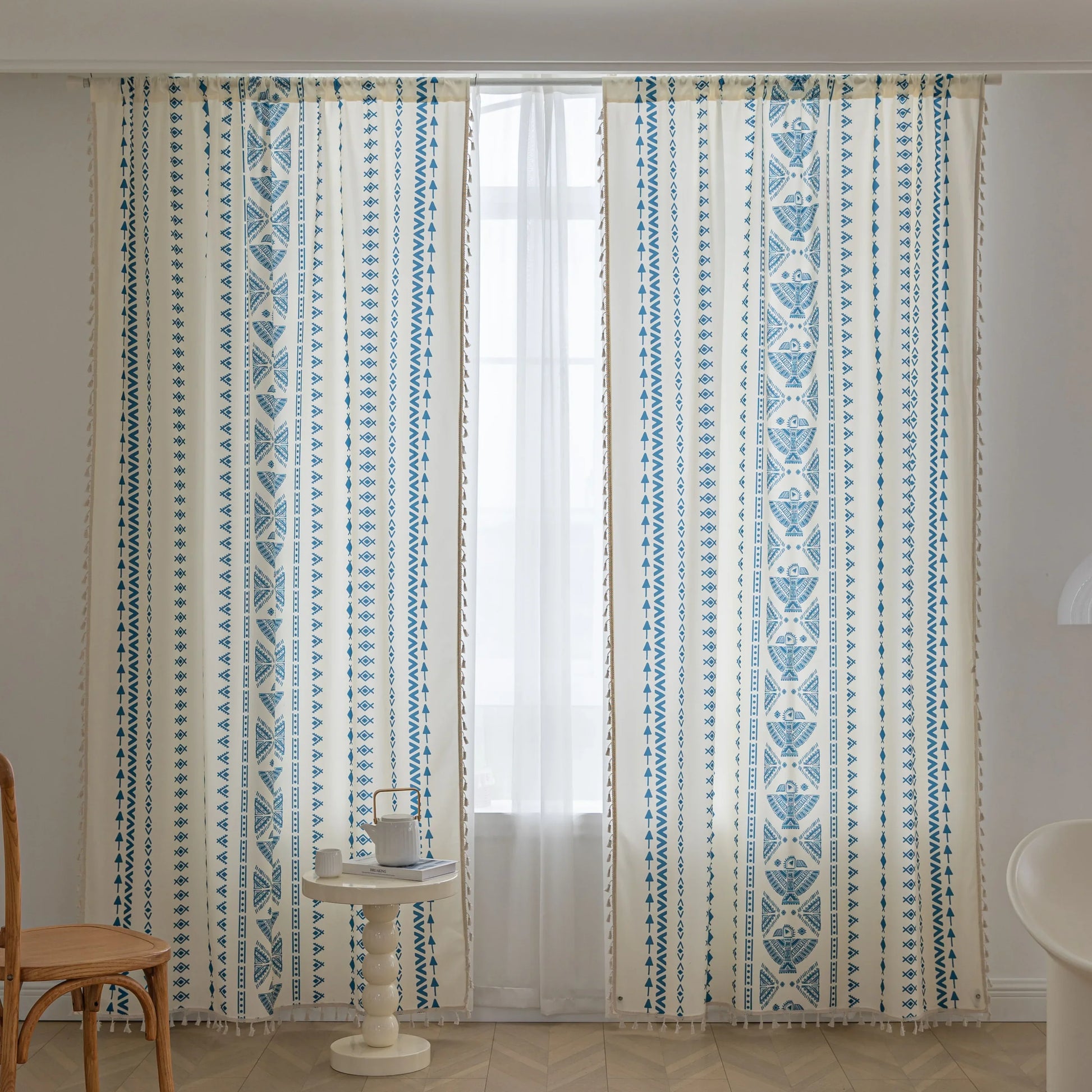 Cream curtain with vertical blue geometric and tribal-inspired patterns.                                                                                                                                                                                                                                                                                                                                                                                                                                                        