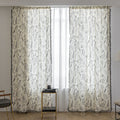 Cream curtains with black botanical print and black tassel trim.
