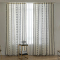 Cream curtains with vertical black tribal and geometric patterns.