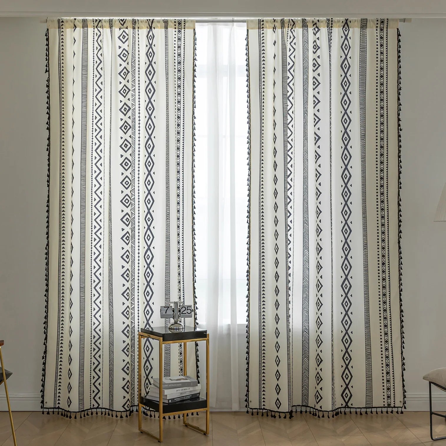 Cream curtains with vertical black tribal and geometric patterns.