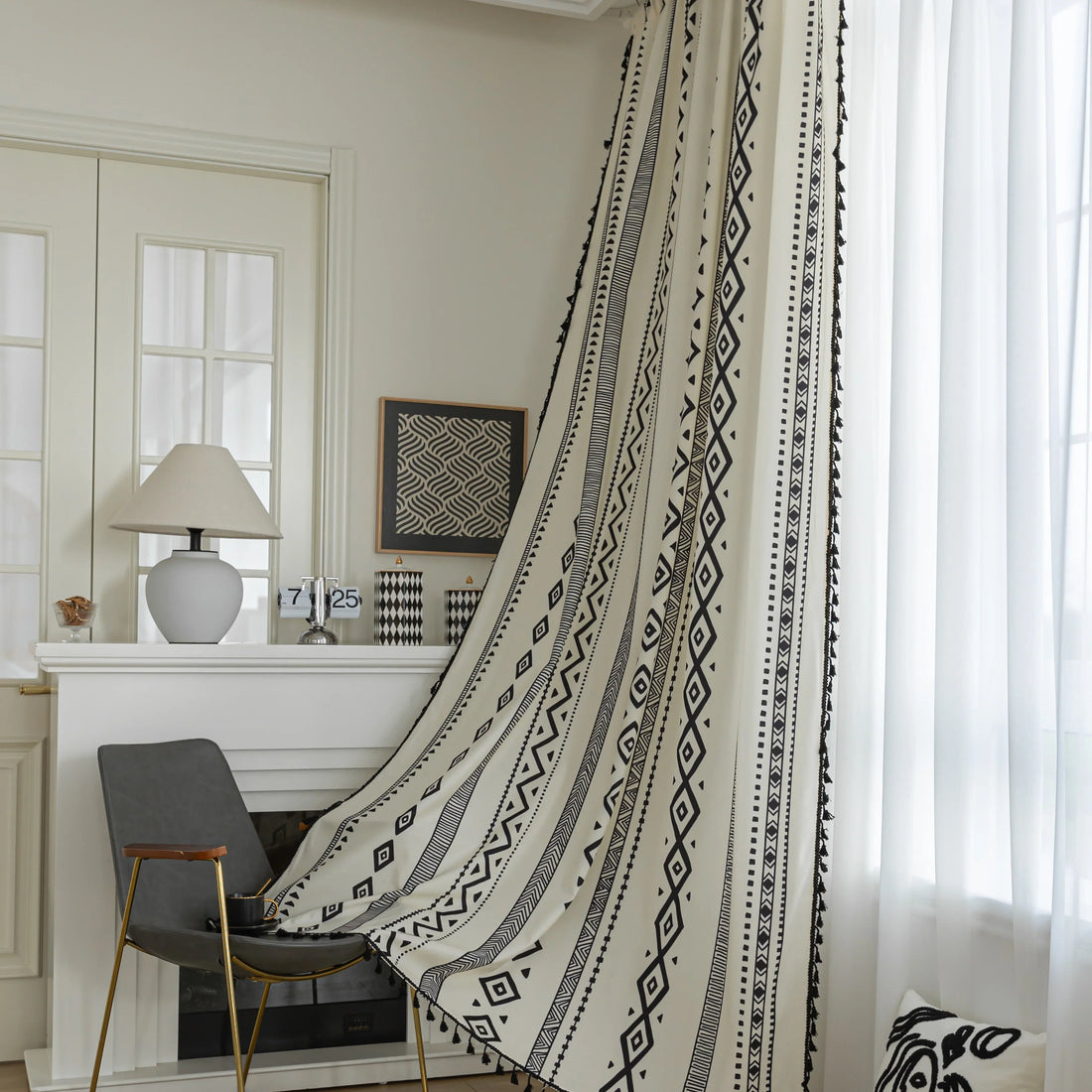 Cream curtain with bold black vertical tribal and geometric patterns, adding a modern bohemian touch to interior decor.