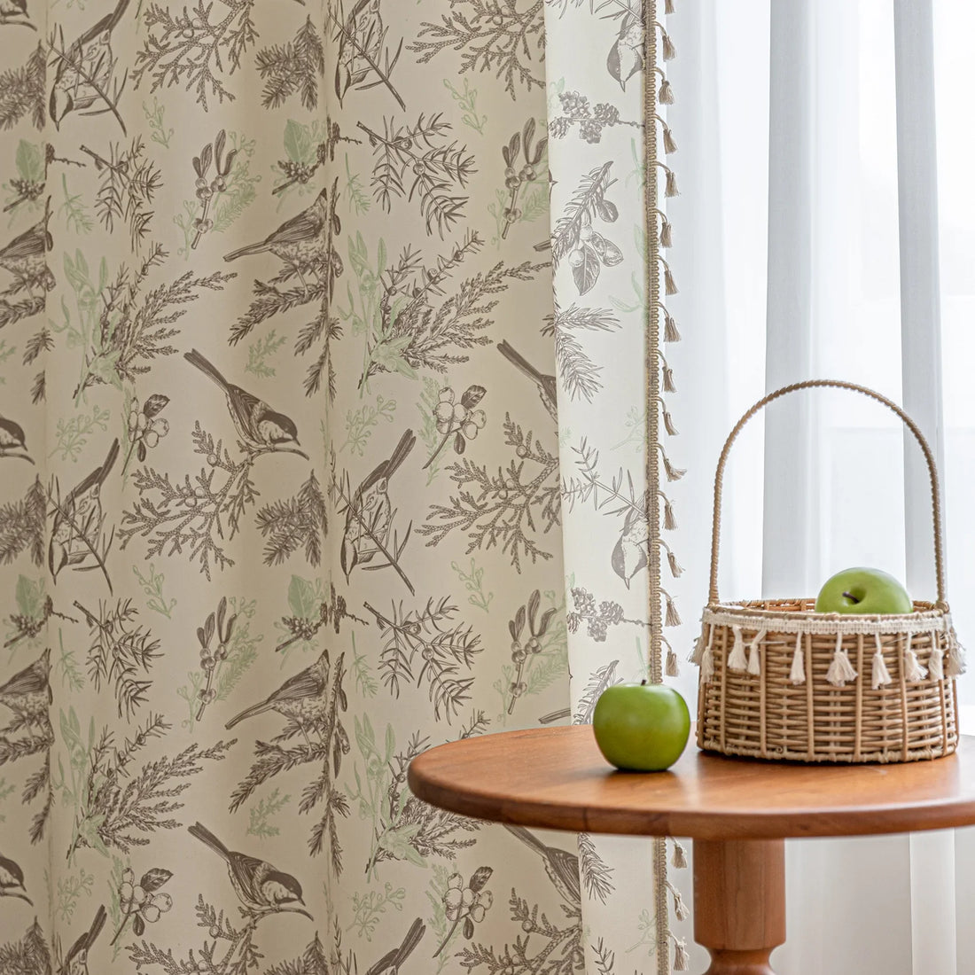 Beige curtain with bird and botanical print in brown and green, featuring decorative tassel trim for a rustic, nature-inspired look.