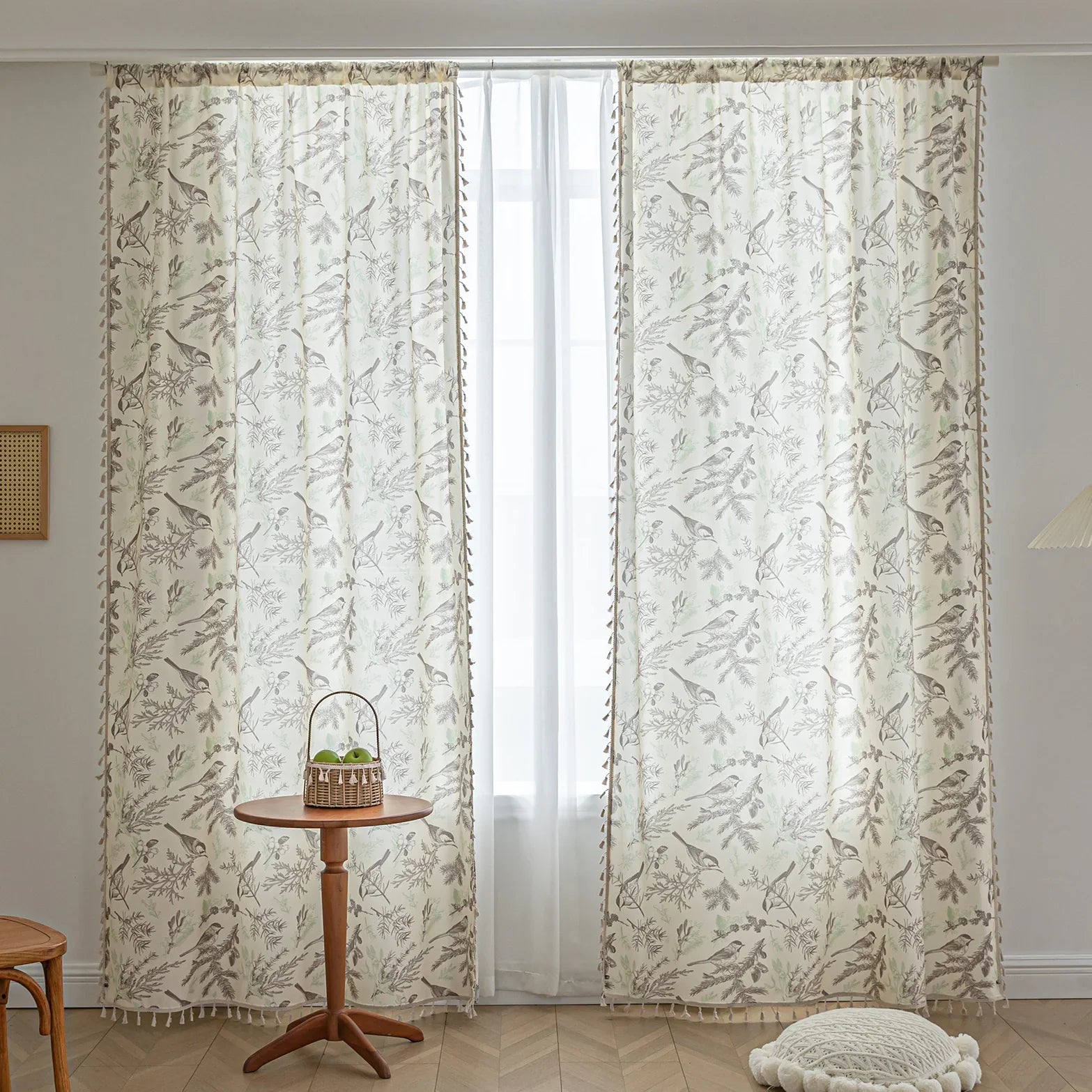 Beige curtain with bird and botanical print in brown and green, featuring decorative tassel trim for a rustic, nature-inspired look.