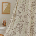 Beige curtain with bird and botanical print in brown and green, featuring decorative tassel trim for a rustic, nature-inspired look.