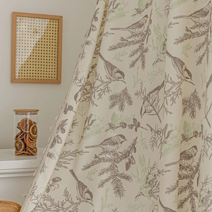 Beige curtain with bird and botanical print in brown and green, featuring decorative tassel trim for a rustic, nature-inspired look.