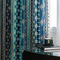 Blue geometric patterned curtain with tribal-inspired design, featuring white tassel trim for a bold and decorative accent.