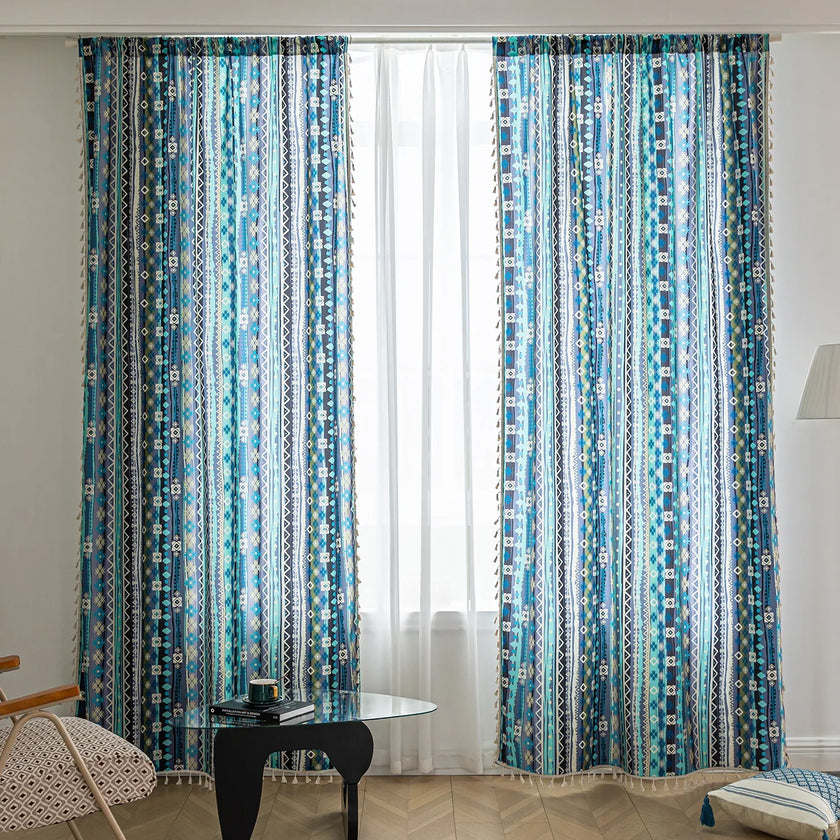 Blue geometric patterned curtain with tribal-inspired design, featuring white tassel trim for a bold and decorative accent.
