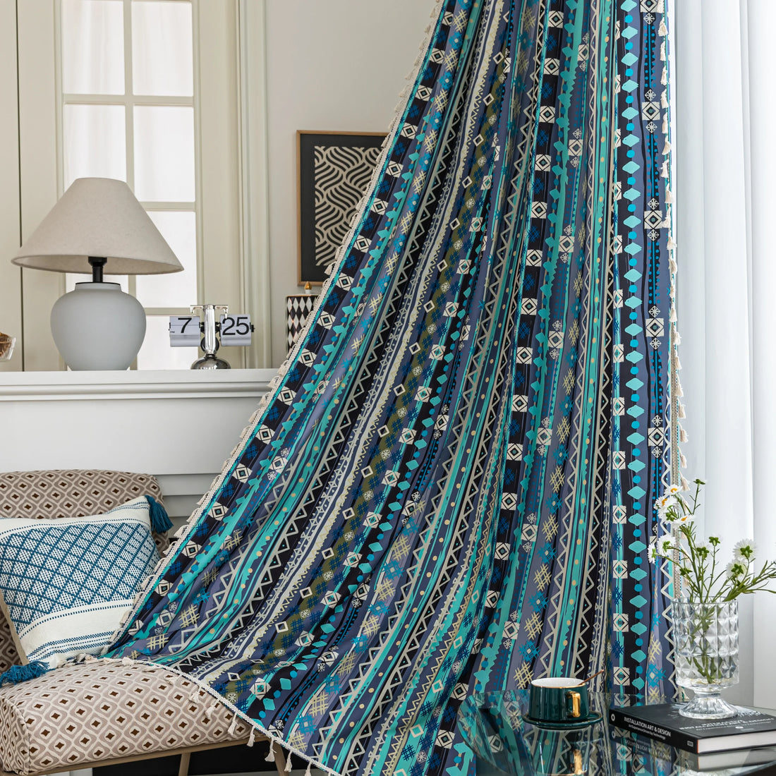 Blue geometric patterned curtain with tribal-inspired design, featuring white tassel trim for a bold and decorative accent.