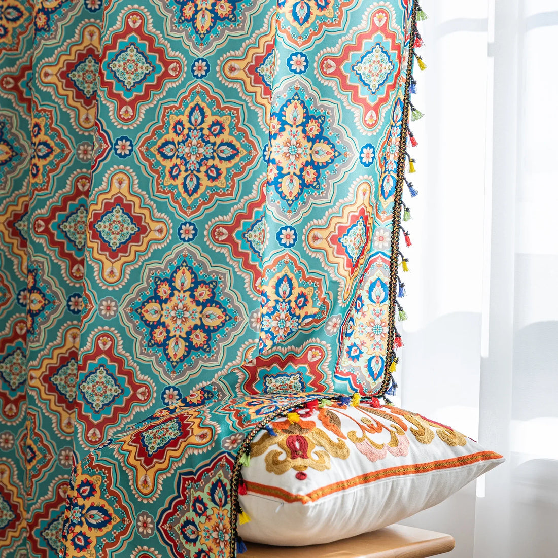 Colorful bohemian-style curtain with intricate geometric and floral patterns in turquoise, red, yellow, and navy, adding a vibrant touch to living room décor.