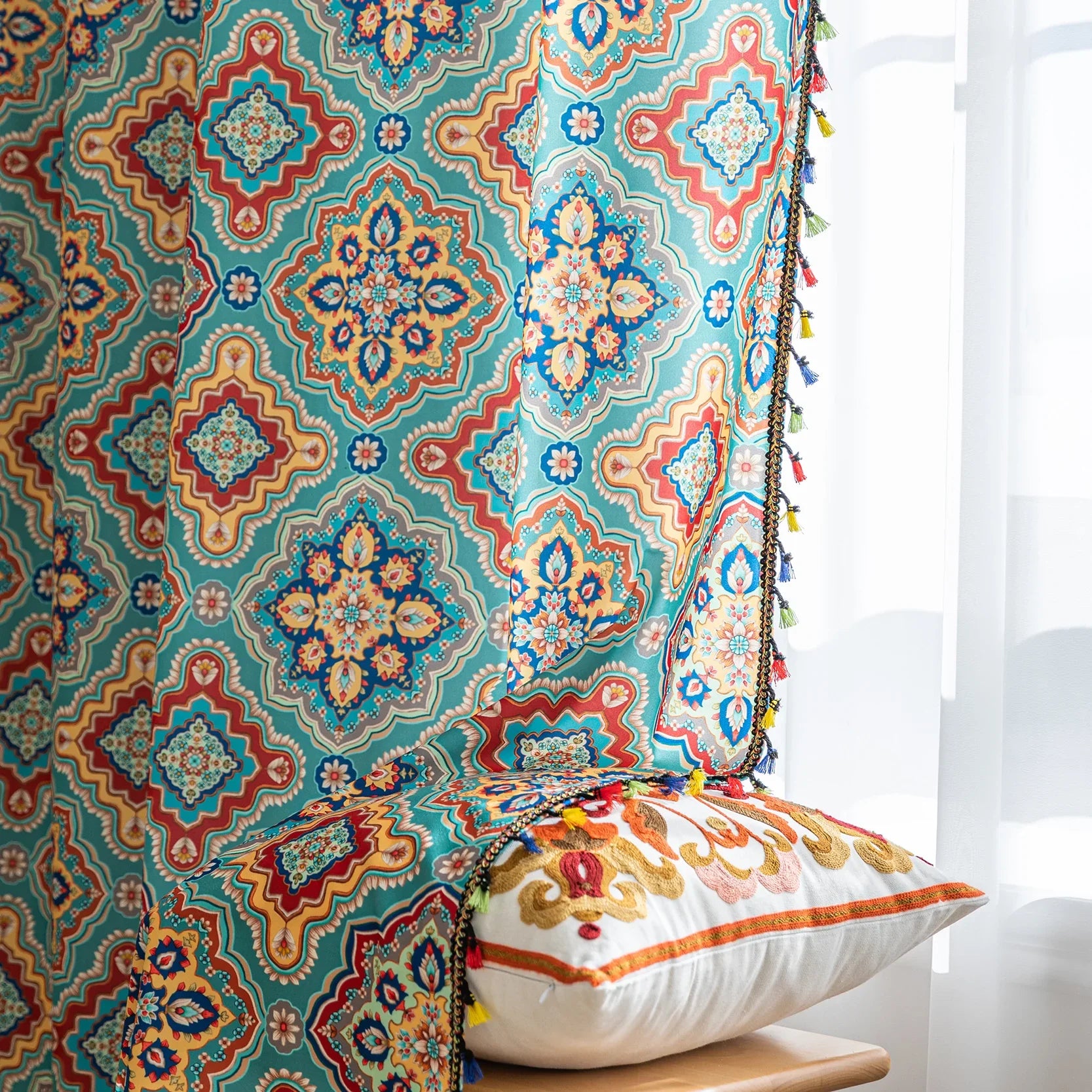 Colorful bohemian-style curtain with intricate geometric and floral patterns in turquoise, red, yellow, and navy, adding a vibrant touch to living room décor.