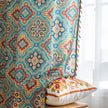 Colorful bohemian-style curtain with intricate geometric and floral patterns in turquoise, red, yellow, and navy, adding a vibrant touch to living room d¨¦cor.