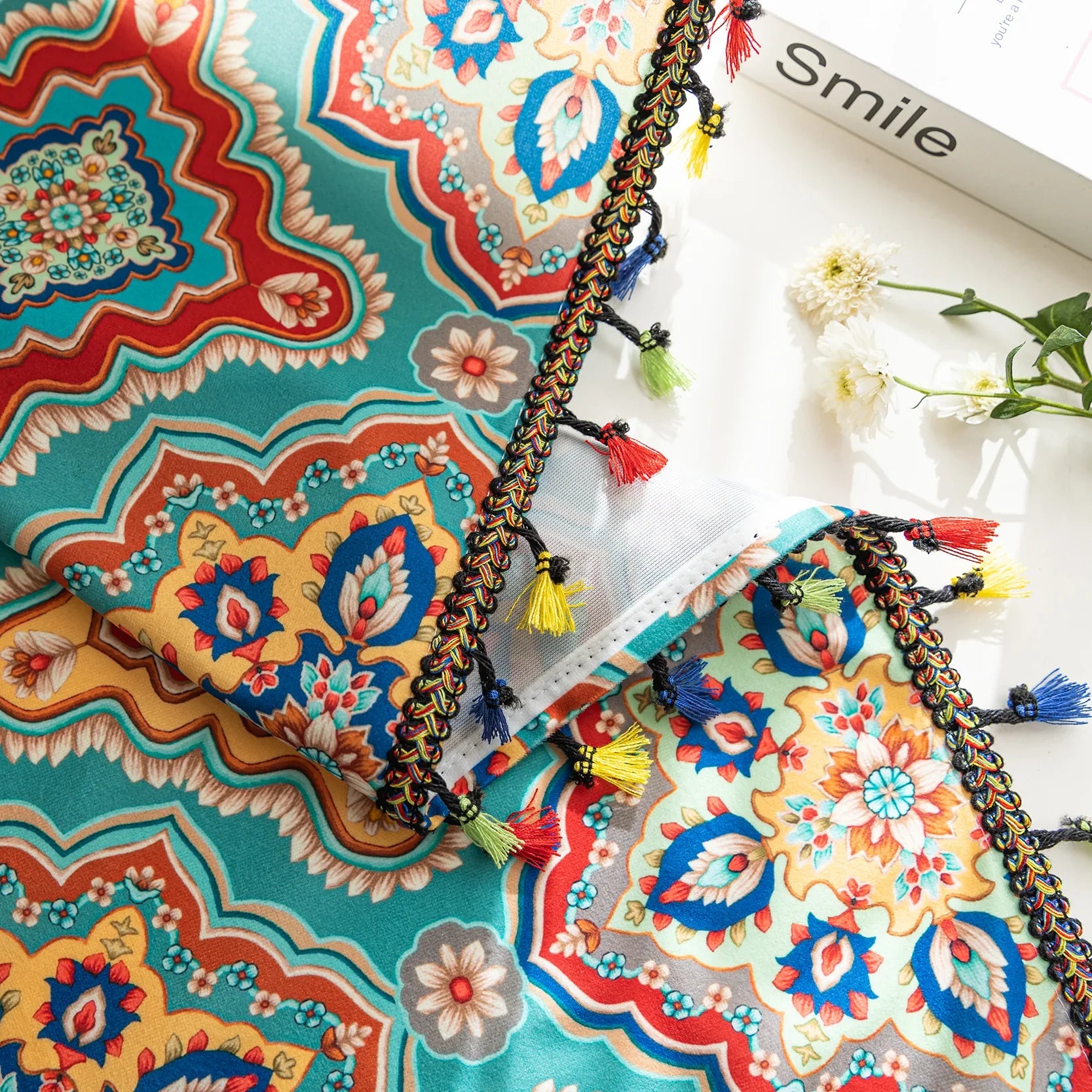 Colorful bohemian-style curtain with intricate geometric and floral patterns in turquoise, red, yellow, and navy, adding a vibrant touch to living room décor.
