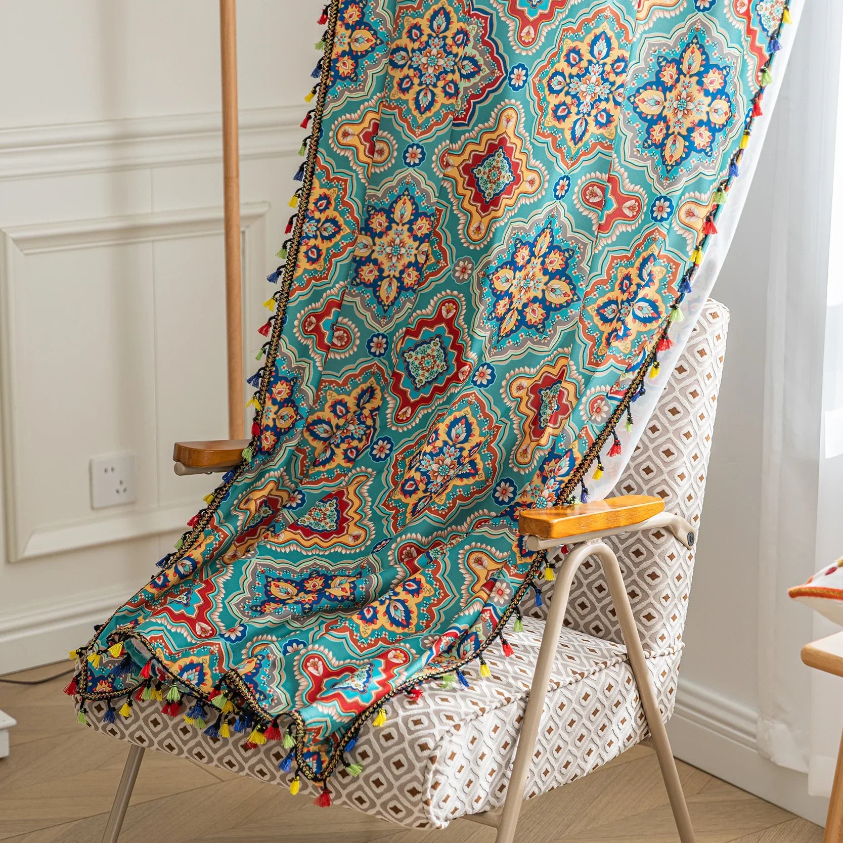 Colorful bohemian-style curtain with intricate geometric and floral patterns in turquoise, red, yellow, and navy, adding a vibrant touch to living room décor.