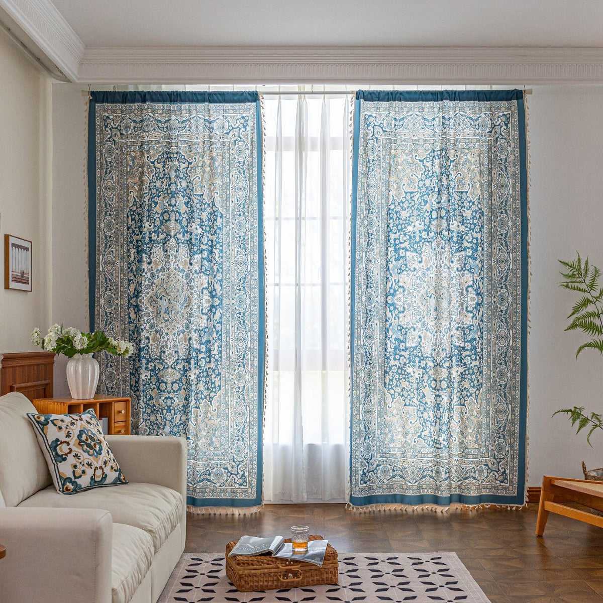 Elegant blue and white patterned curtains with intricate Persian-inspired design, framing a sheer white panel for a bright and stylish living room d¨¦cor.