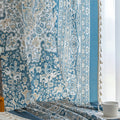 Elegant blue and white patterned curtains with intricate Persian-inspired design.
