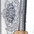 Black and white curtain fabric with Greek key pattern and floral accents, featuring decorative black tassel trim for a bold and elegant home décor style.