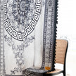 Black and white curtain fabric with Greek key pattern and floral accents, featuring decorative black tassel trim for a bold and elegant home d¨¦cor style.