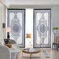 Black and white curtain fabric with Greek key pattern and floral accents, featuring decorative black tassel trim for a bold and elegant home décor style.