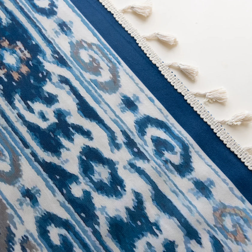 Blue and white curtain fabric with abstract watercolor-style pattern, accented by solid blue border and decorative white tassel trim for a coastal and artistic home d¨¦cor look.

