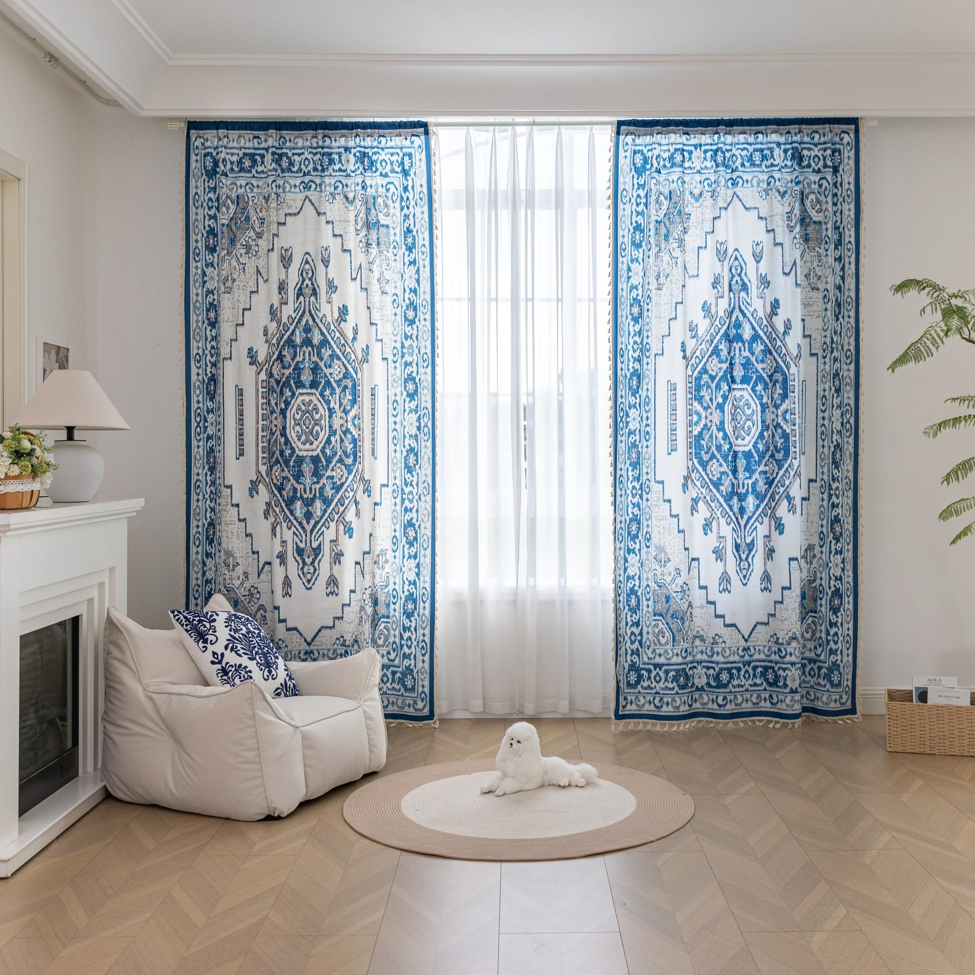 Blue and white curtain fabric with abstract watercolor-style pattern, accented by solid blue border and decorative white tassel trim for a coastal and artistic home décor look.

