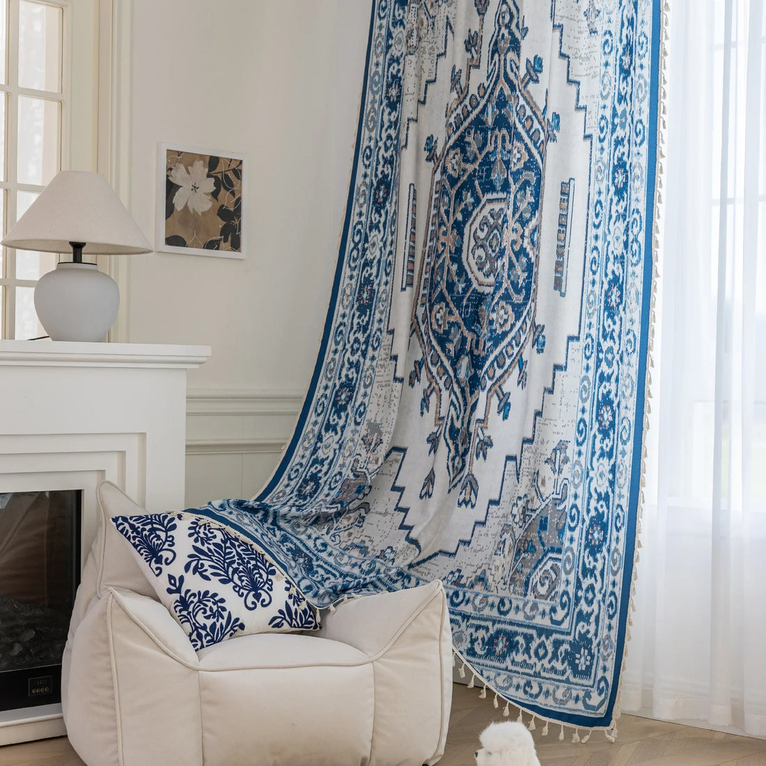 Blue and white curtain fabric with abstract watercolor-style pattern, accented by solid blue border and decorative white tassel trim for a coastal and artistic home décor look.