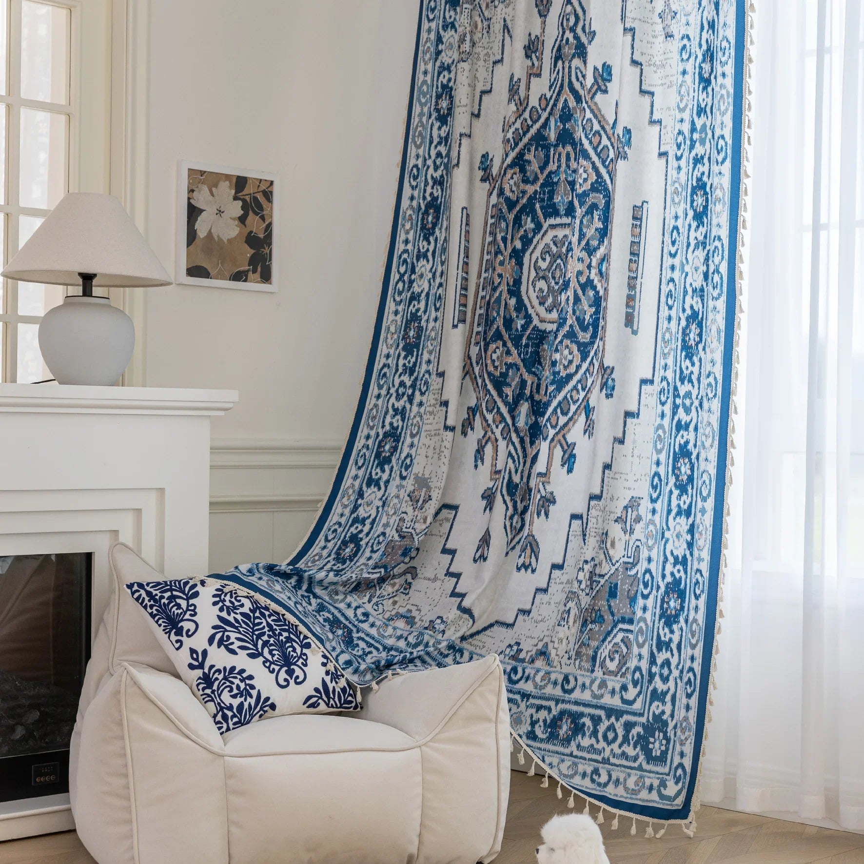 Blue and white curtain fabric with abstract watercolor-style pattern, accented by solid blue border and decorative white tassel trim for a coastal and artistic home décor look.