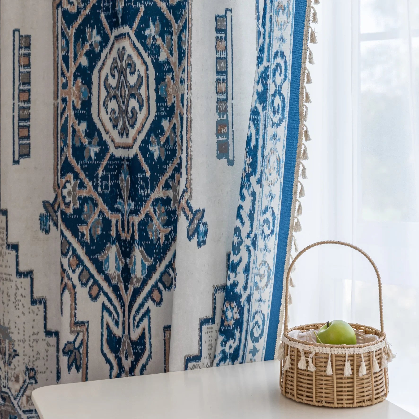 Blue and white curtain fabric with abstract watercolor-style pattern, accented by solid blue border and decorative white tassel trim for a coastal and artistic home décor look.