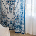 Blue and white curtain fabric with abstract watercolor-style pattern, accented by solid blue border and decorative white tassel trim for a coastal and artistic home décor look.