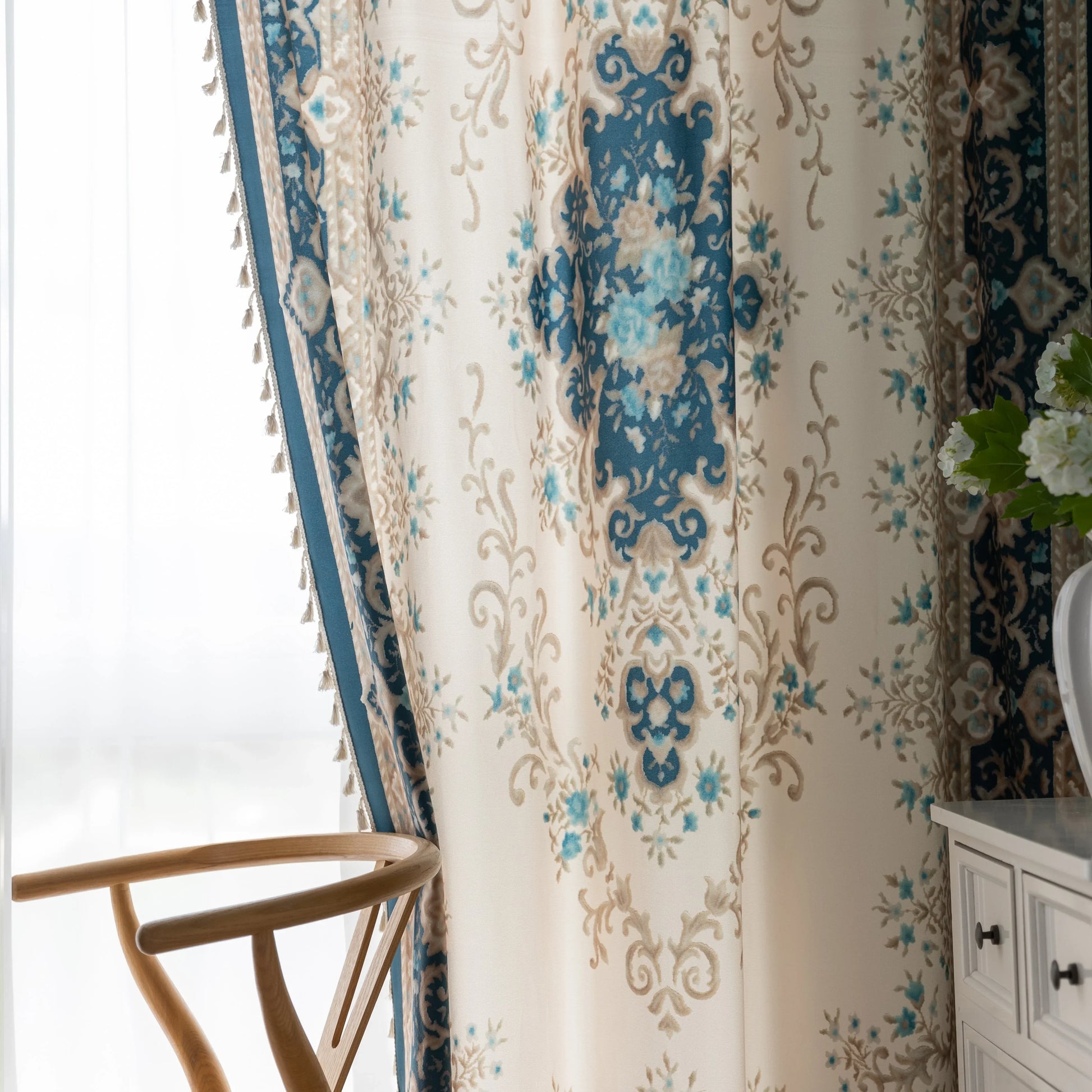 Close-up of an elegant curtain with intricate floral and medallion design in teal, beige, and gold tones, featuring ornate scrolling patterns for a classic and luxurious home décor look.