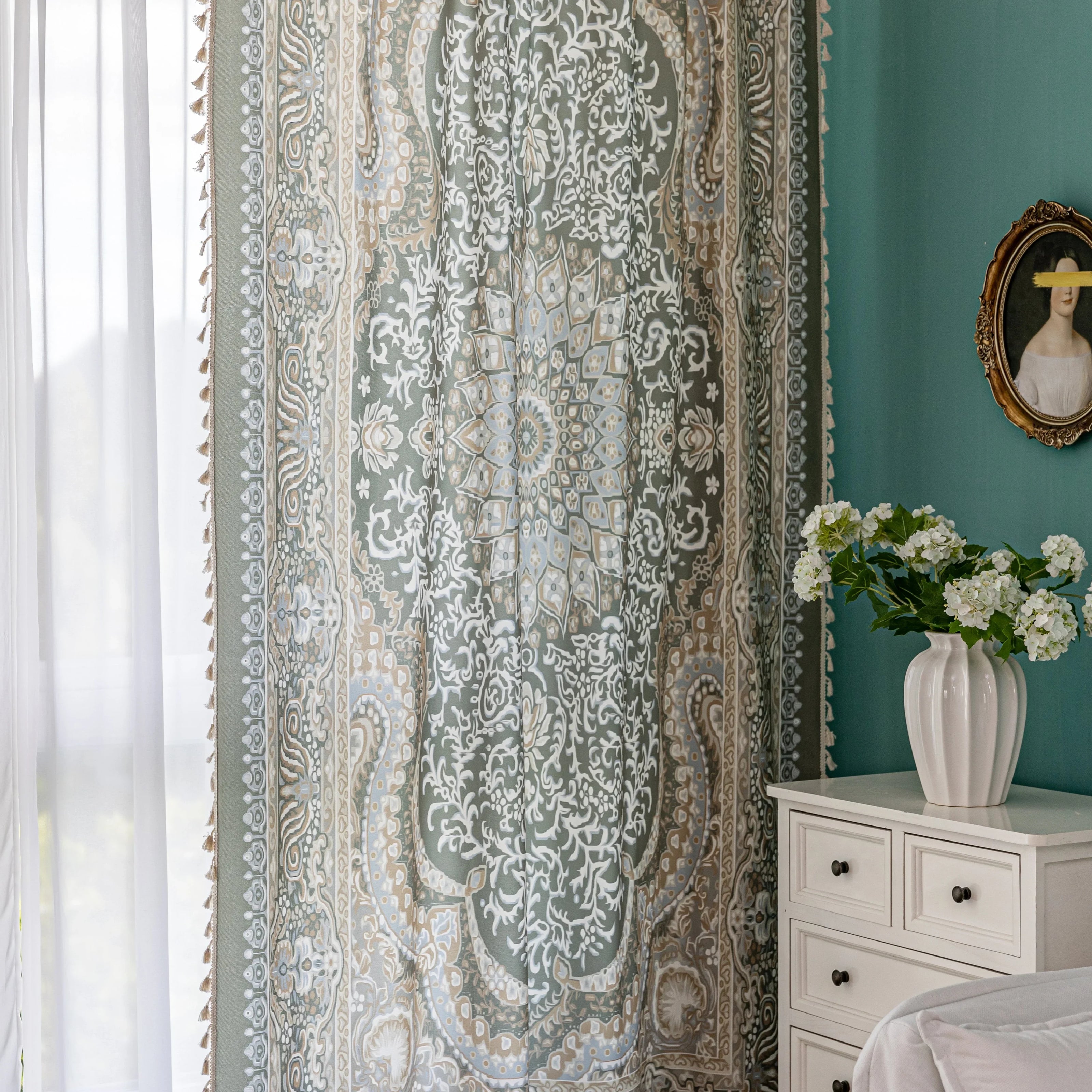 Close-up of an ornate curtain featuring a green background with intricate white floral and medallion patterns, accented with beige and gold details for a vintage, luxurious home d¨¦cor style.