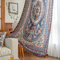 Colorful bohemian curtain with intricate floral and medallion patterns in navy blue, red, green, and cream, adorned with multicolored tassels.