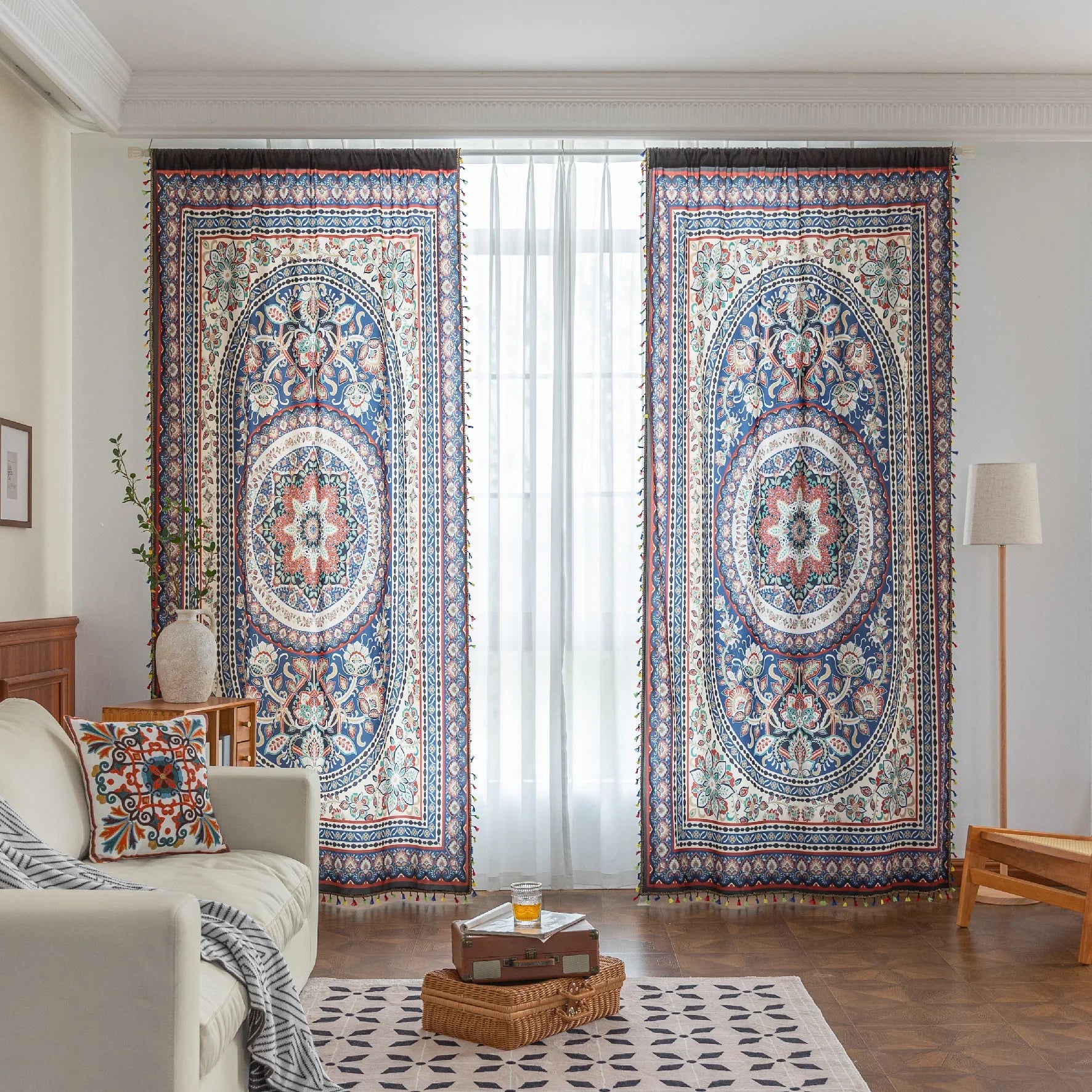 Colorful bohemian curtain with intricate floral and medallion patterns in navy blue, red, green, and cream, adorned with multicolored tassels.