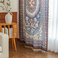 Colorful bohemian curtain with intricate floral and medallion patterns in navy blue, red, green, and cream, adorned with multicolored tassels.