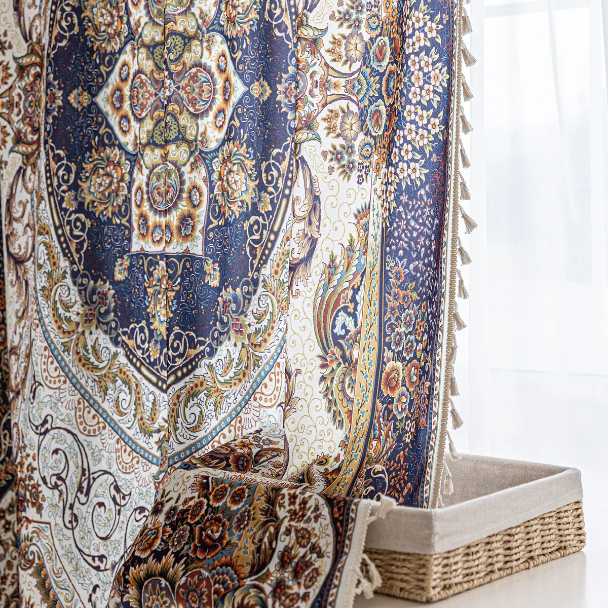 Iuxurious Persian-inspired curtain fabric featuring intricate floral and paisley patterns in navy blue, gold, and rust tones, accented with fine woven details and decorative tassel edging.