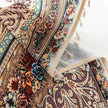 Close-up of a luxurious curtain with intricate floral and paisley patterns in rich brown, teal, and burgundy tones, adorned with delicate tassel trim for an elegant, classic home d¨¦cor style.