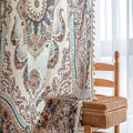 luxurious curtain with intricate floral and paisley patterns in rich brown, teal, and burgundy tones, adorned with delicate tassel trim for an elegant, classic home décor style.