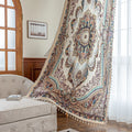 luxurious curtain with intricate floral and paisley patterns in rich brown, teal, and burgundy tones, adorned with delicate tassel trim for an elegant, classic home décor style.