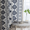 Stylish bohemian curtain featuring bold black geometric and cross patterns on a neutral background, accented with decorative tassel trim — perfect for adding a modern tribal touch to your living room, bedroom, or eclectic home décor.
