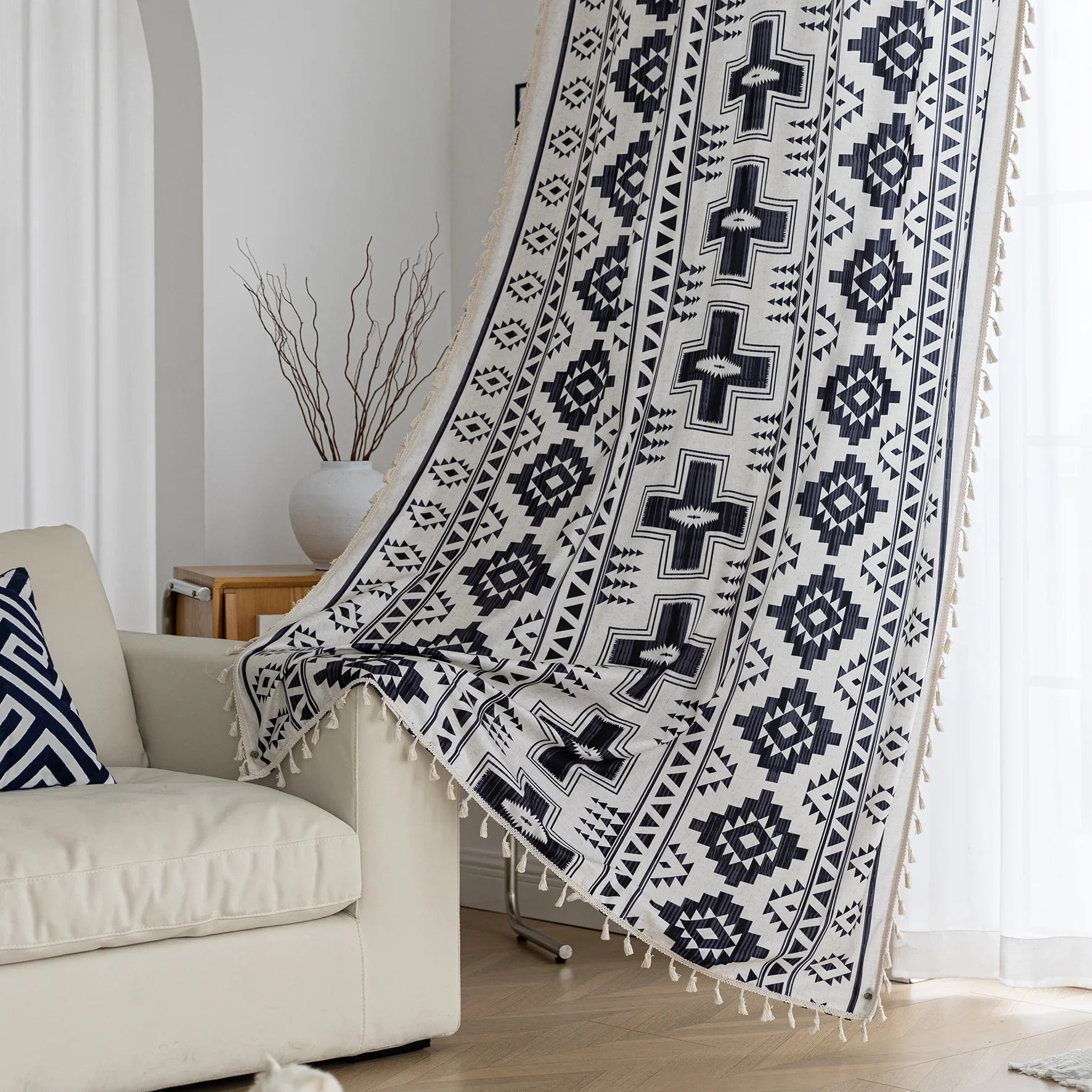 Stylish bohemian curtain featuring bold black geometric and cross patterns on a neutral background, accented with decorative tassel trim — perfect for adding a modern tribal touch to your living room, bedroom, or eclectic home décor.