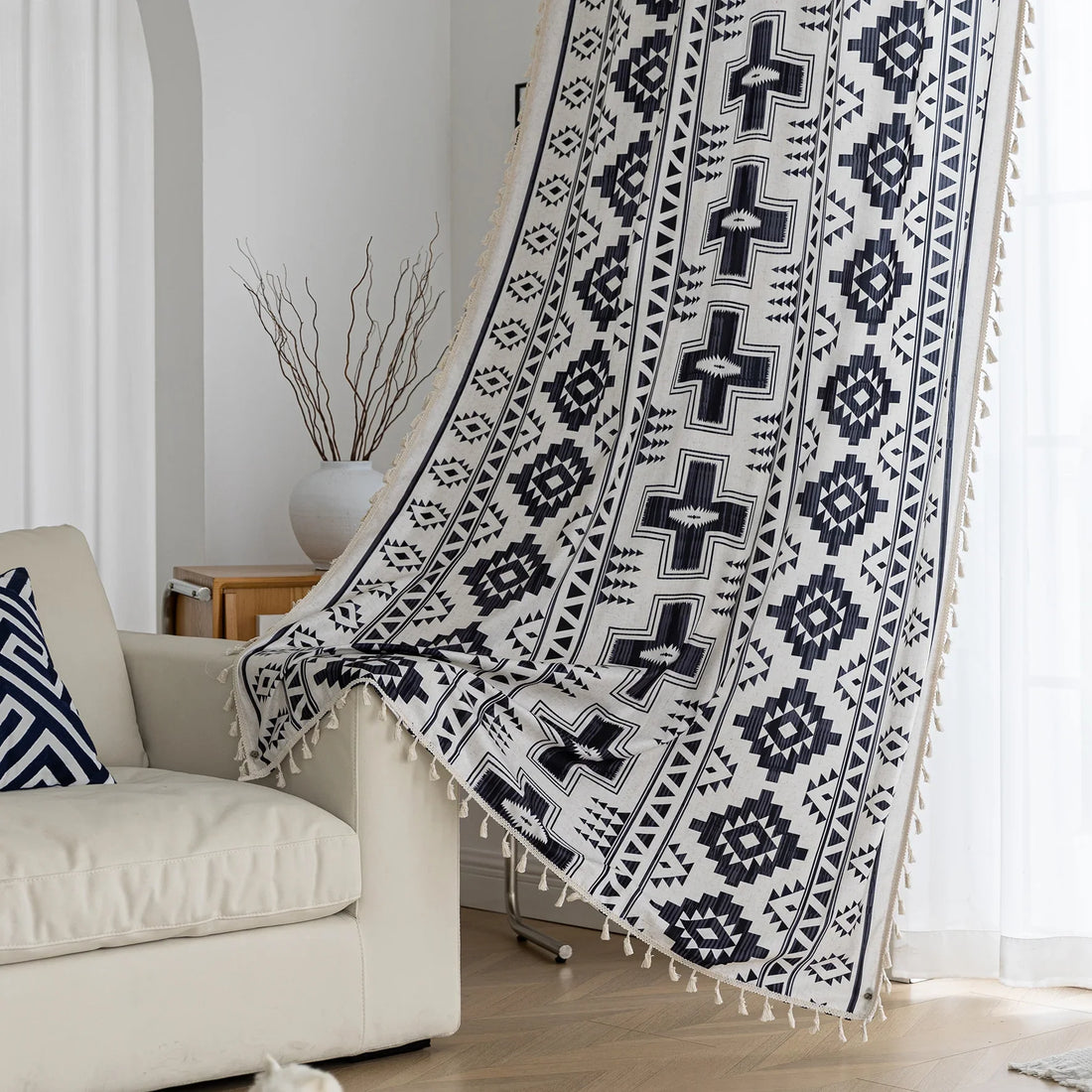 Stylish bohemian curtain featuring bold black geometric and cross patterns on a neutral background, accented with decorative tassel trim — perfect for adding a modern tribal touch to your living room, bedroom, or eclectic home décor.