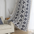 Stylish bohemian curtain featuring bold black geometric and cross patterns on a neutral background, accented with decorative tassel trim — perfect for adding a modern tribal touch to your living room, bedroom, or eclectic home décor.
