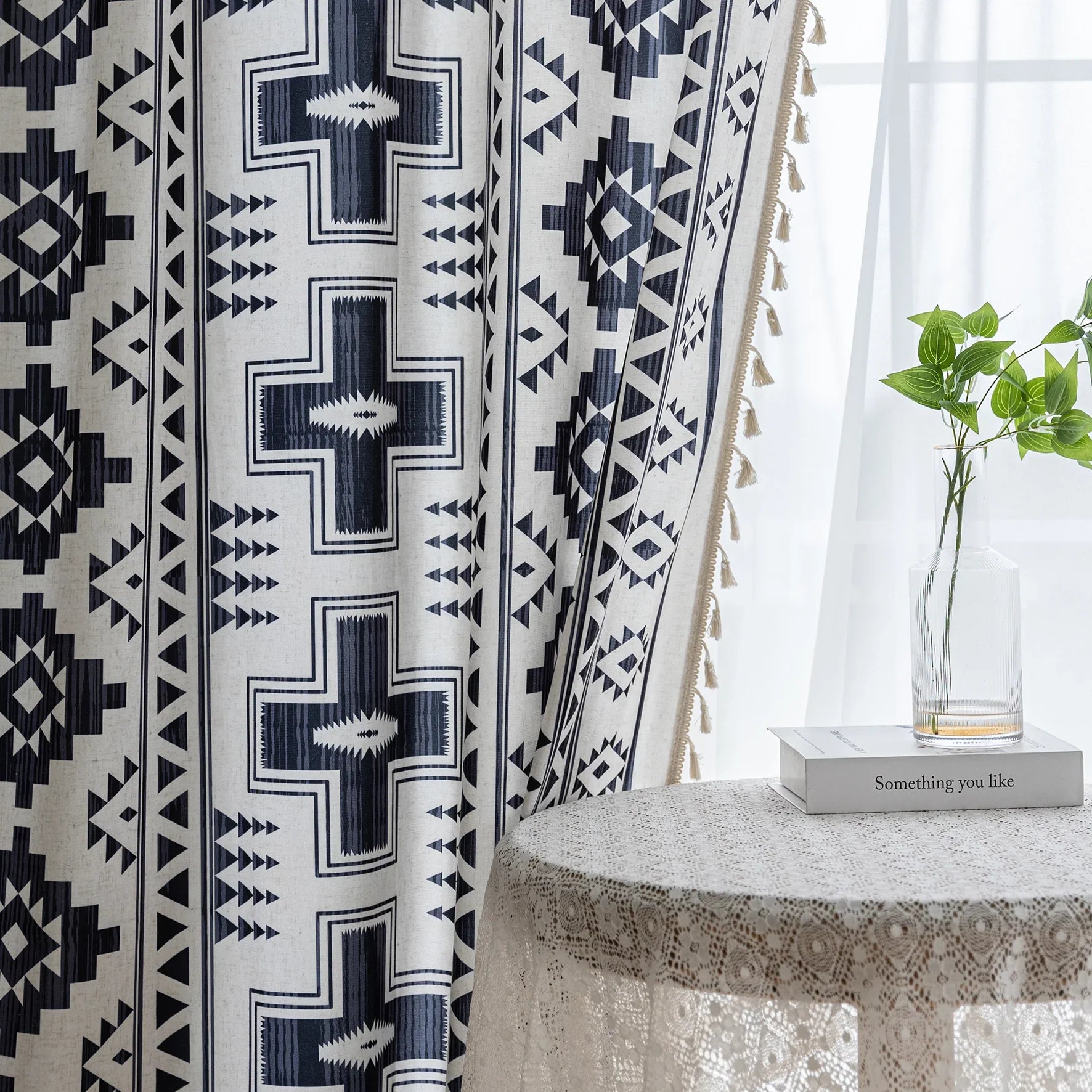 Stylish bohemian curtain featuring bold black geometric and cross patterns on a neutral background, accented with decorative tassel trim — perfect for adding a modern tribal touch to your living room, bedroom, or eclectic home décor.