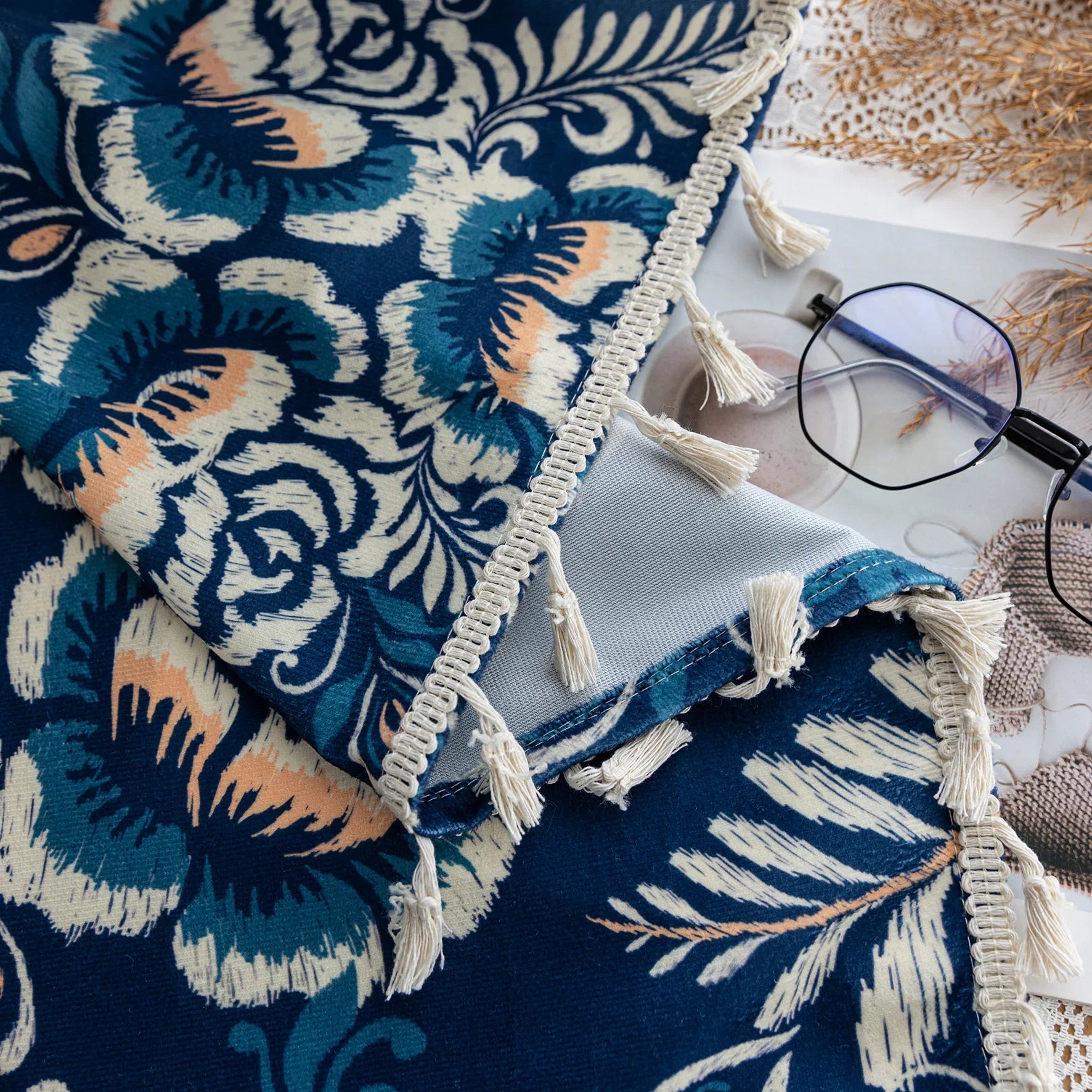 Elegant navy blue curtain adorned with intricate beige floral and leafy patterns, finished with delicate tassel trim — ideal for adding a touch of sophistication and classic charm to living rooms, bedrooms, or vintage-inspired interiors.